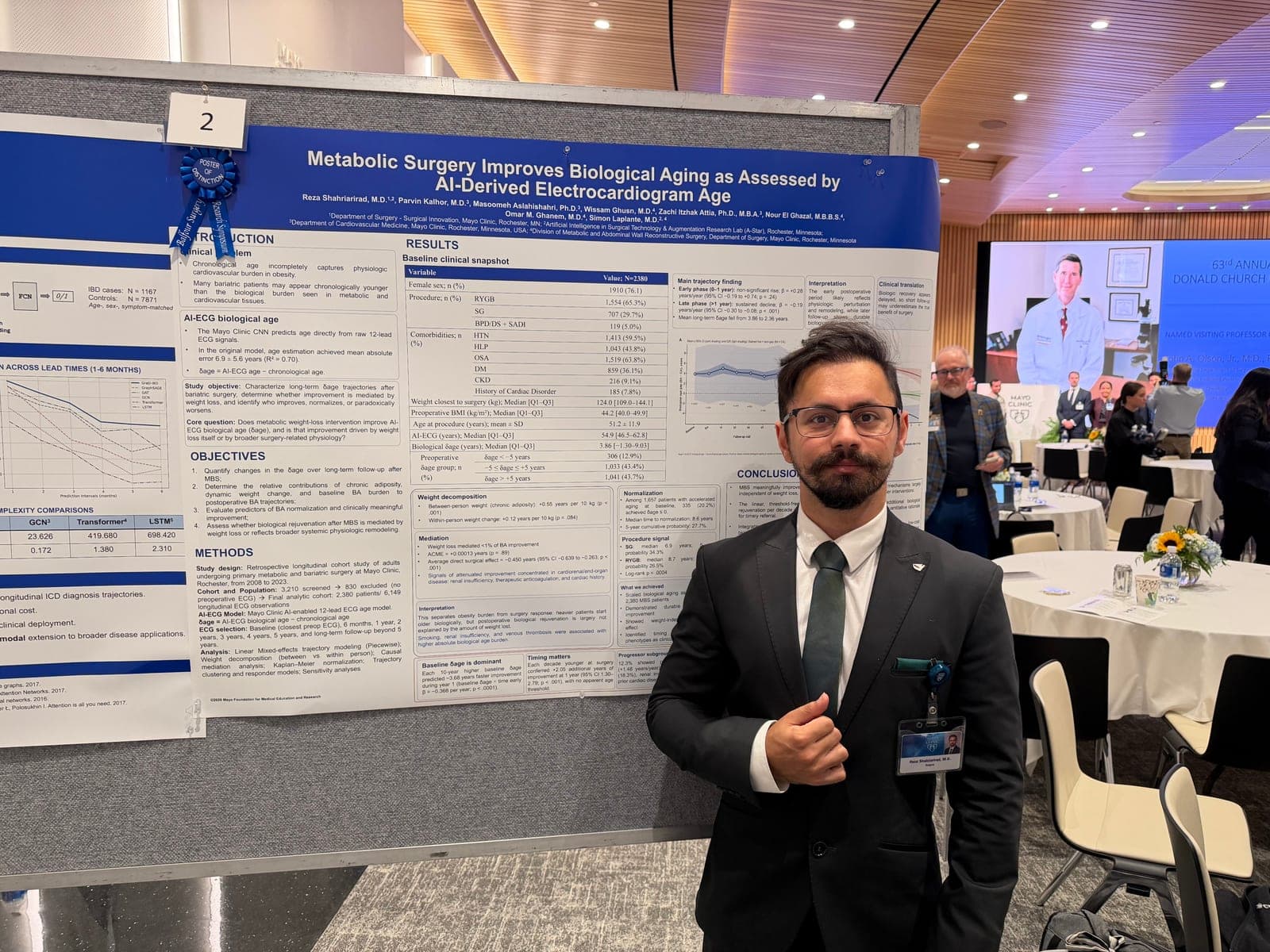 Dr. Reza Shahriarirad beside the AI-ECG biological aging poster, marked with a Poster of Distinction ribbon.