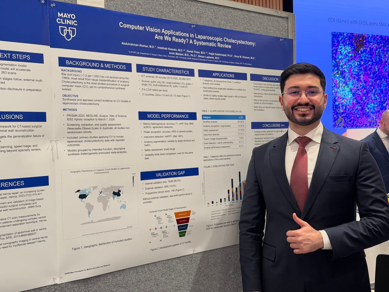 Dr. Abdulrahman Alomar beside the lab's systematic review poster on computer vision in laparoscopic cholecystectomy.